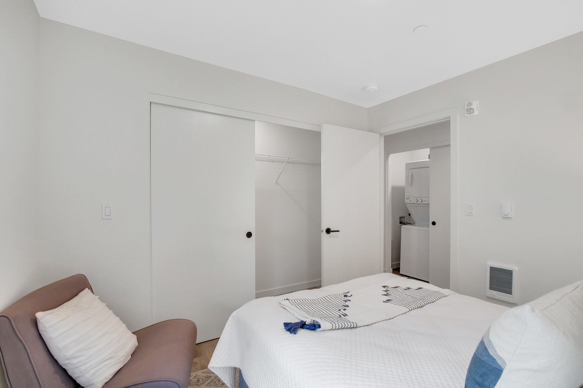 Bedroom with closet and view of in-unit washer/dryer